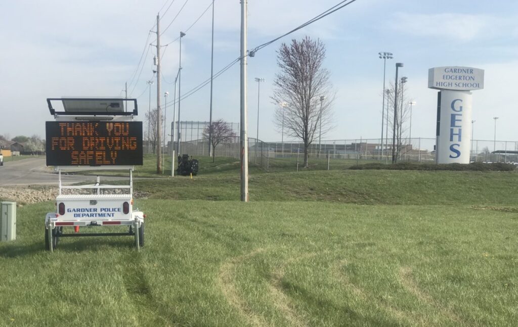 The Gardner Police Department using message board sign to encourage safe driving in front of a high school.