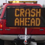 VMS Board on the hitch of a truck warning of crash