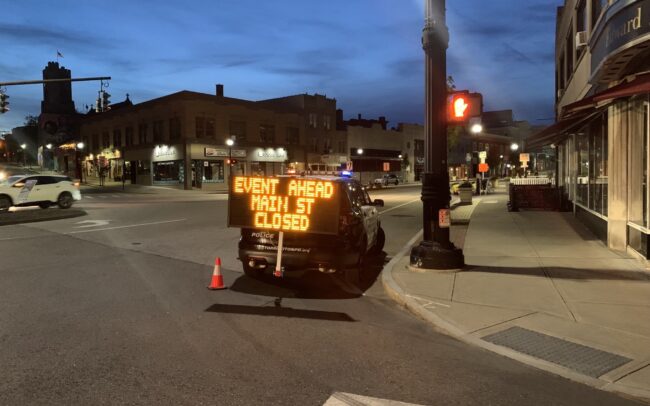 Instalert on a vehicle hitch mount can assist with traffic management for community events