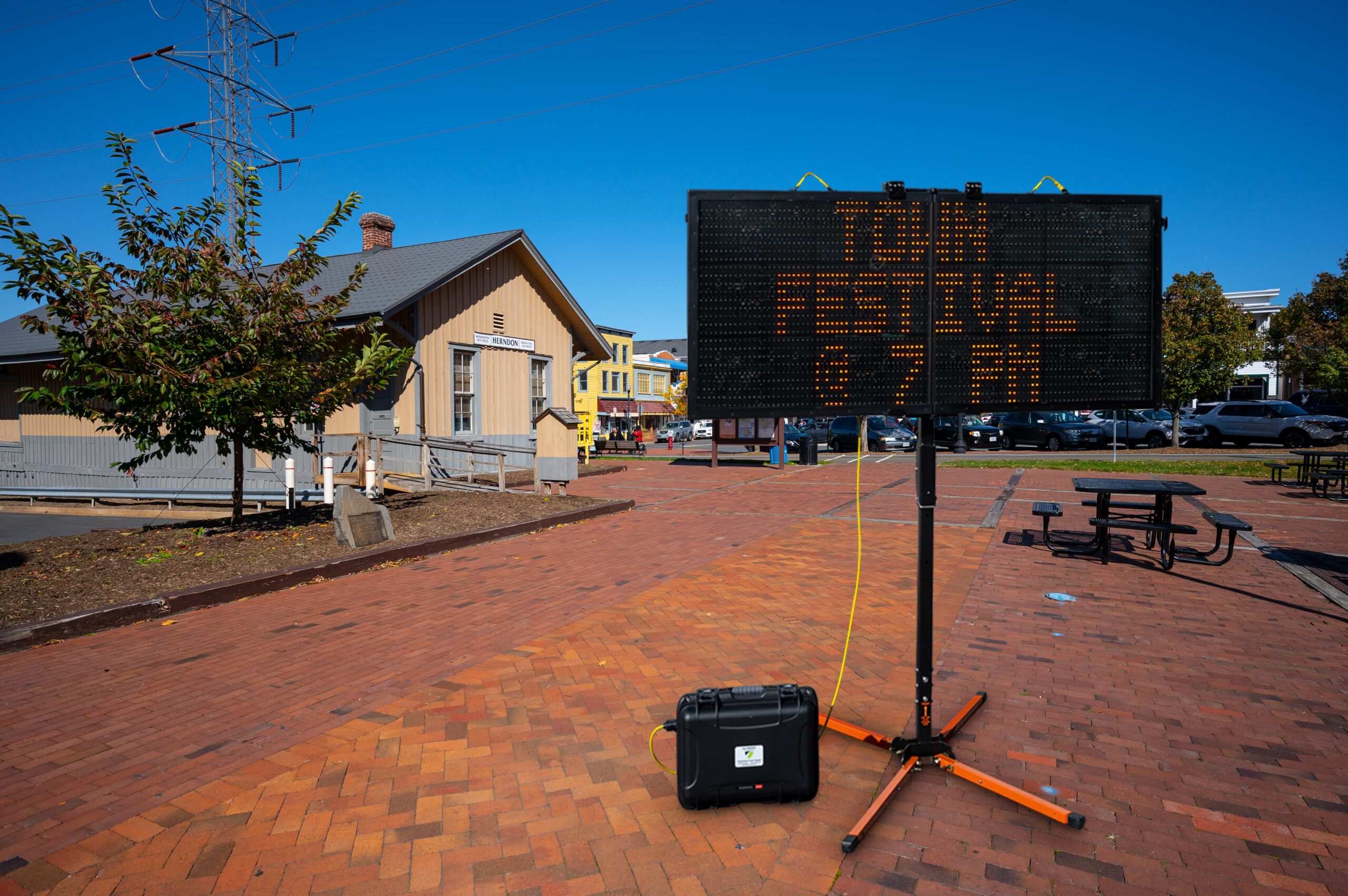 Portable changeable message sign sharing information about a town festival